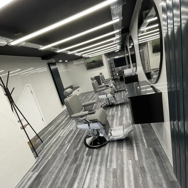 Inside Fredo's Barbershop: chairs, round mirrors and the grey timber floor